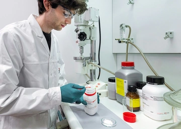 Researcher mixes solid electrolytes at the laboratory