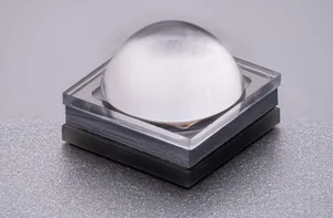 Close-up of a square LED with a transparent, dome-shaped lens.