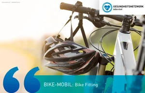 Fahrradlenker mit daran hängendem Fahrradhelm vor unscharfem Hintergrund