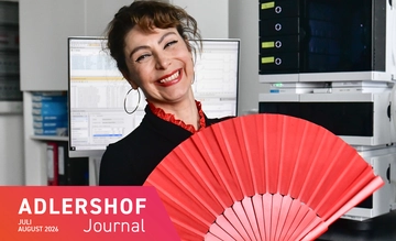Anna Romanotto in an office holding a fan used in flamenco dancing