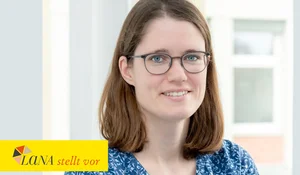 Frau mit schulterlangen braunen Haaren und Brille lächelt in einem hellen Raum