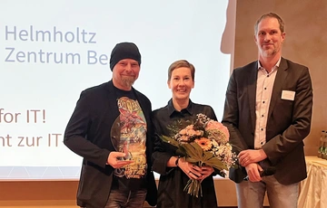 Winners with trophy and flowers