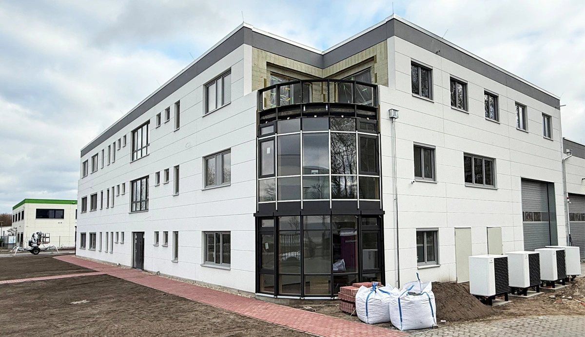 Photo of the building, link starts PDF download