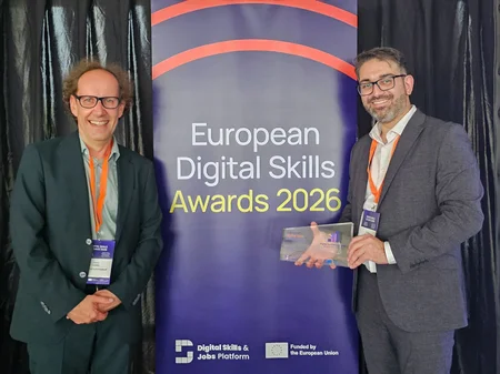 Two people with the award