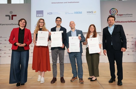 People with certificates in their hands